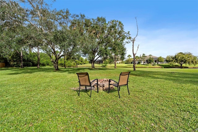 view of yard with an outdoor fire pit