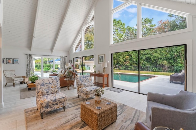 living room featuring beam ceiling and high vaulted ceiling