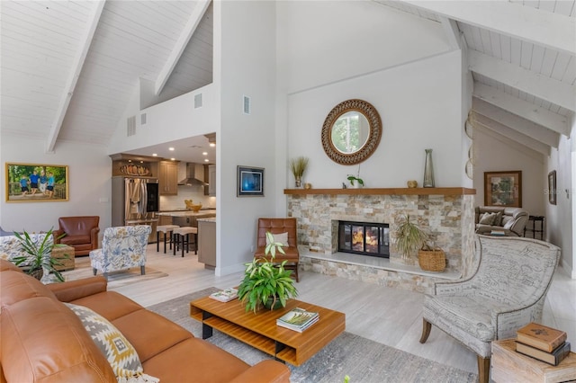 living room featuring beamed ceiling, high vaulted ceiling, wood ceiling, and a fireplace