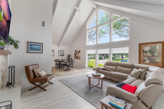 living room with beamed ceiling and high vaulted ceiling