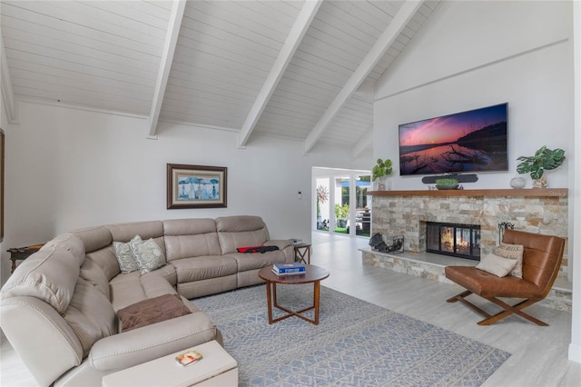 living room with a stone fireplace, high vaulted ceiling, beam ceiling, and light wood-type flooring