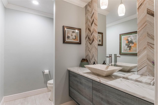 bathroom with crown molding, vanity, toilet, and tile patterned flooring