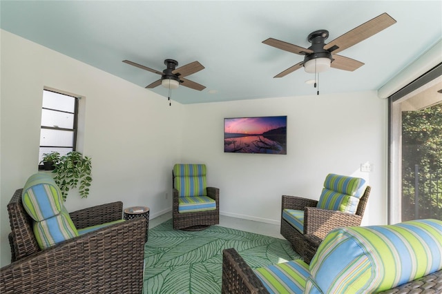 living area featuring ceiling fan and carpet flooring