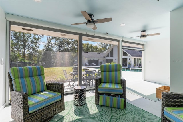 sunroom featuring ceiling fan