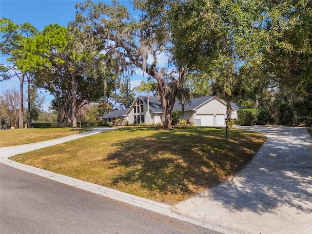 view of front of house with a garage and a front lawn