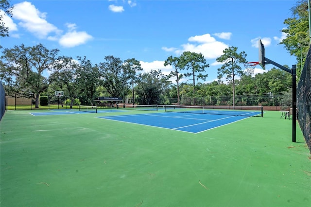 view of tennis court with basketball hoop