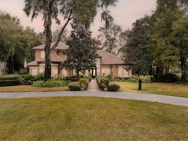 mediterranean / spanish-style house featuring a yard