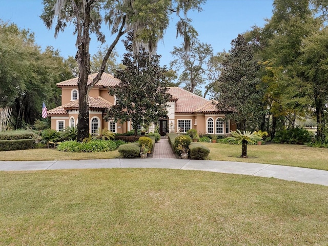 mediterranean / spanish-style home featuring a front yard