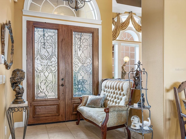 foyer with light tile patterned floors and a wealth of natural light