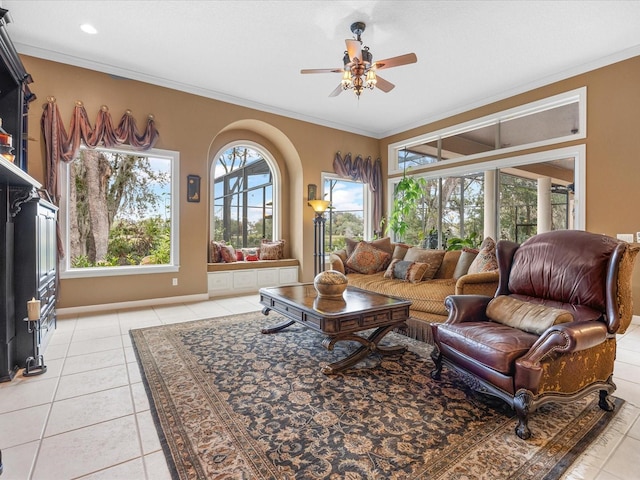 tiled living room with ceiling fan and ornamental molding