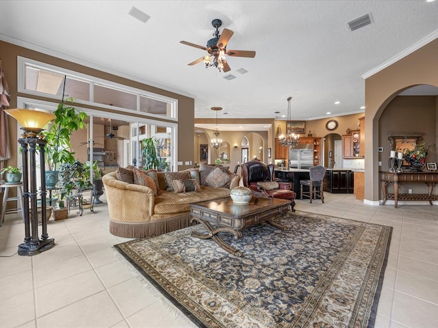 tiled living room featuring crown molding, ceiling fan with notable chandelier, and a textured ceiling