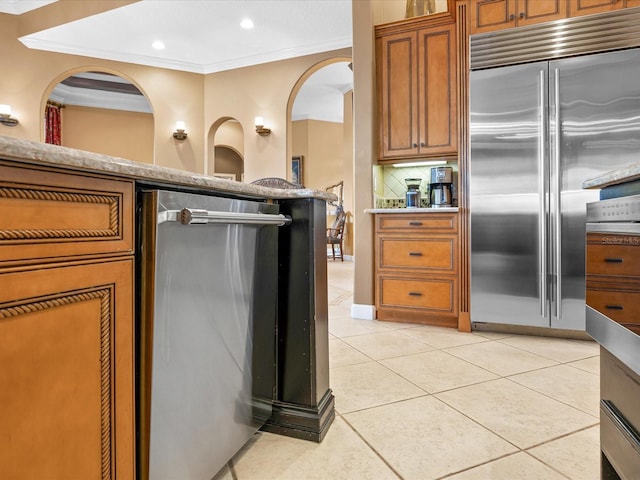 kitchen featuring tasteful backsplash, ornamental molding, stainless steel appliances, and light tile patterned floors