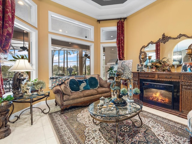 living room with ornamental molding, light tile patterned flooring, and ceiling fan