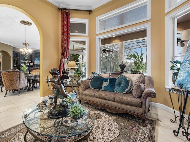 living room with an inviting chandelier, ornamental molding, and plenty of natural light