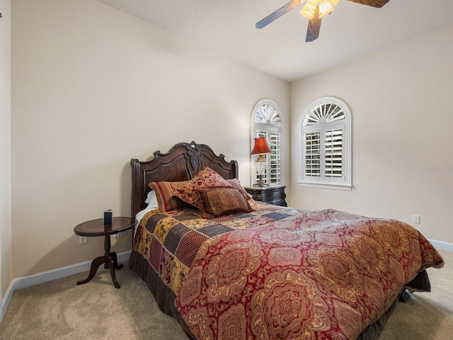 bedroom featuring light colored carpet and ceiling fan