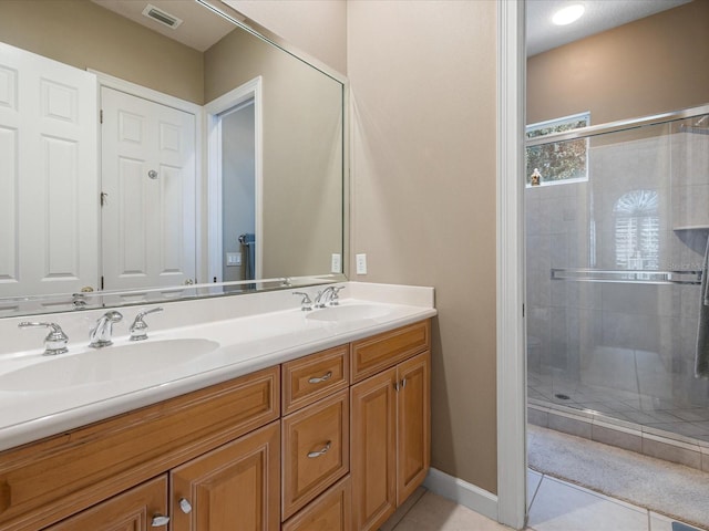 bathroom with vanity, tile patterned floors, and walk in shower