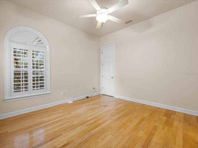 empty room with hardwood / wood-style floors and ceiling fan