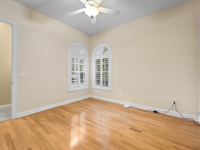 empty room with ceiling fan and light wood-type flooring