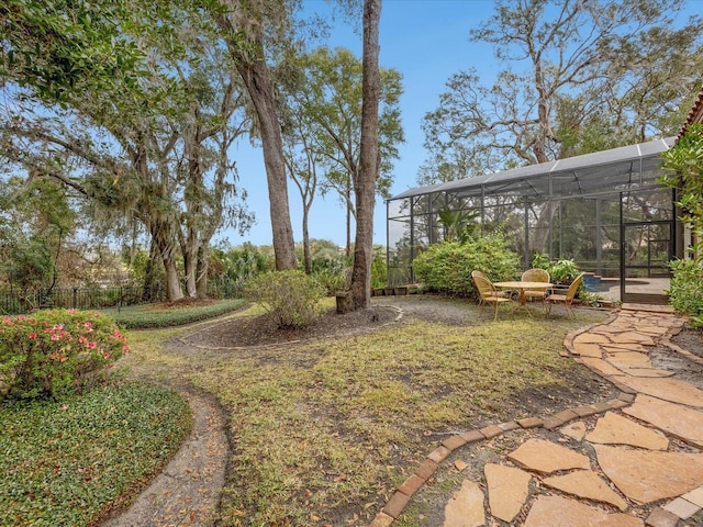 view of yard featuring glass enclosure