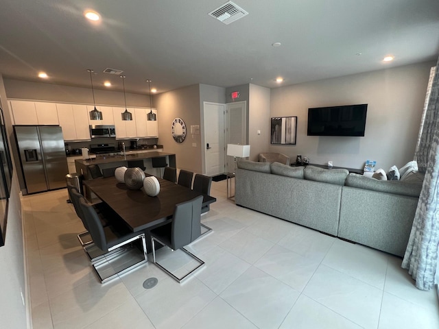 dining space with sink and light tile patterned floors