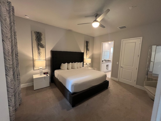 bedroom featuring ceiling fan, ensuite bathroom, and carpet flooring