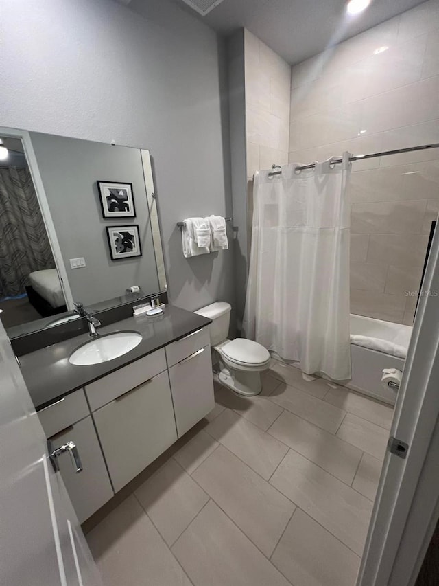 full bathroom with toilet, shower / tub combo, tile patterned flooring, and vanity