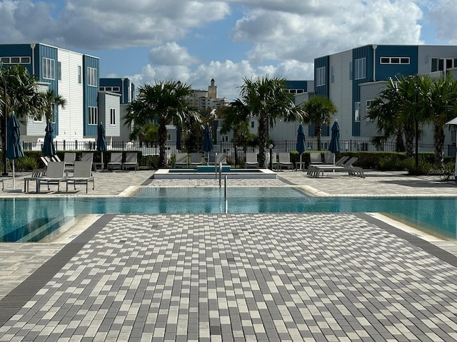 view of swimming pool featuring a patio area and a jacuzzi