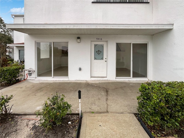 entrance to property with a patio area