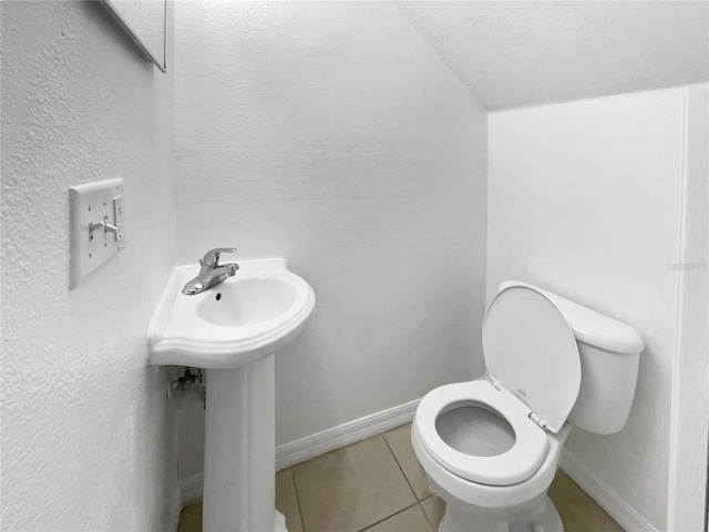 bathroom featuring sink, toilet, and tile patterned flooring