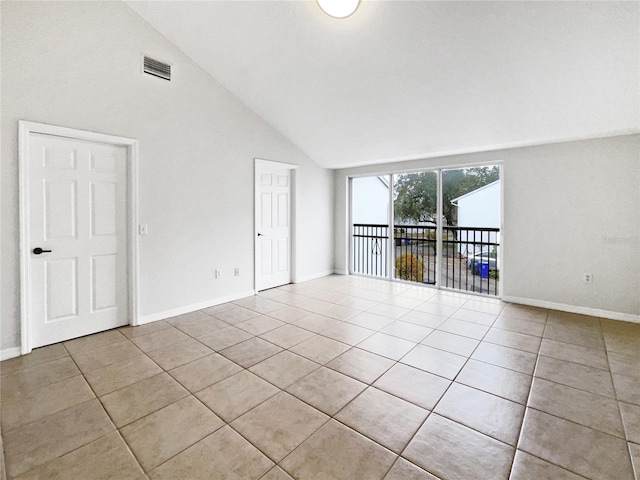 tiled empty room with high vaulted ceiling