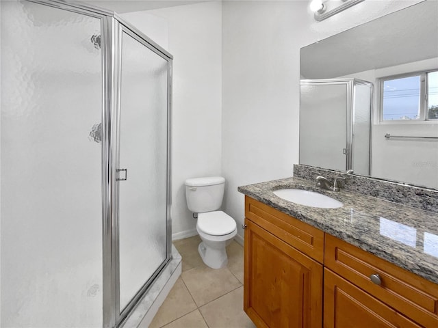 bathroom featuring tile patterned flooring, vanity, and a shower with shower door