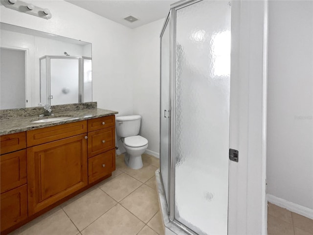 bathroom featuring walk in shower, vanity, toilet, and tile patterned flooring