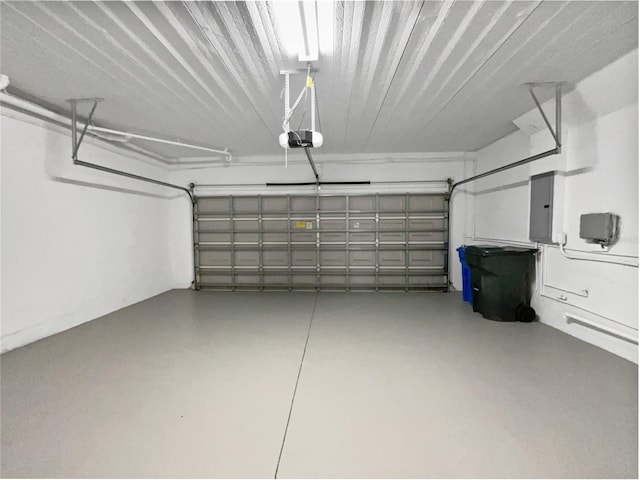 garage with a garage door opener and electric panel