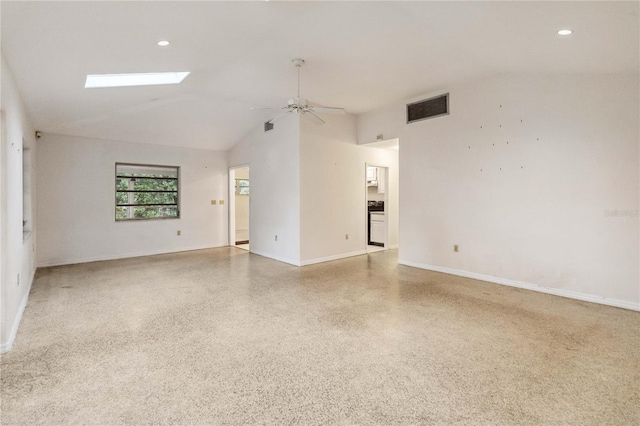 empty room with ceiling fan and a skylight