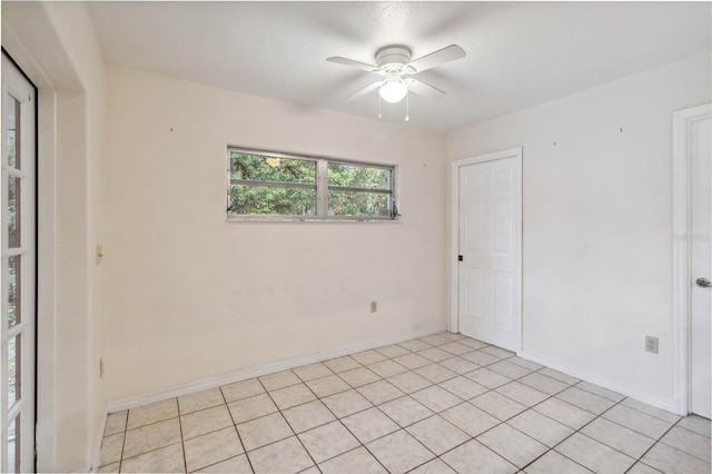 unfurnished room with light tile patterned flooring and ceiling fan