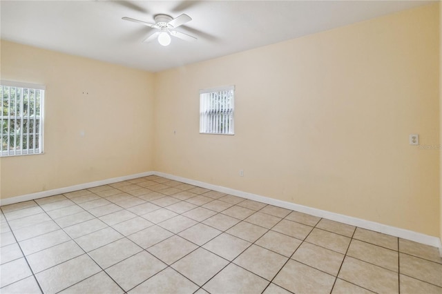 spare room featuring ceiling fan and light tile patterned flooring