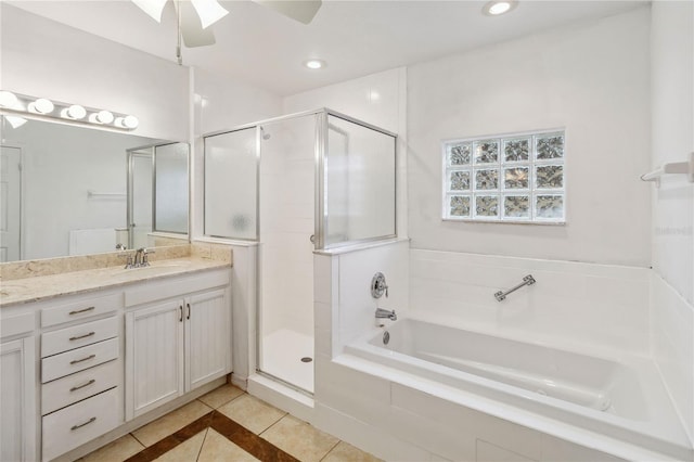 bathroom with ceiling fan, vanity, plus walk in shower, and tile patterned flooring