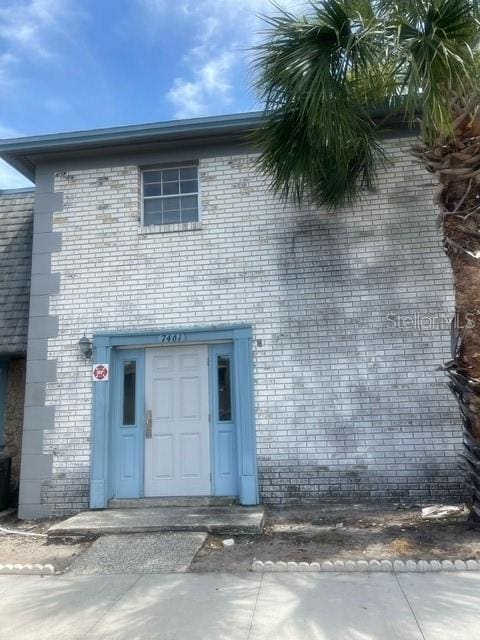 exterior space with brick siding