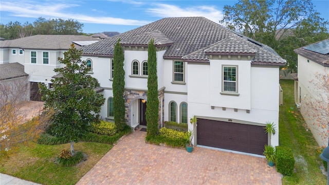 mediterranean / spanish-style home with a garage