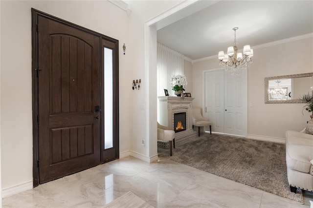 carpeted foyer with ornamental molding and a notable chandelier