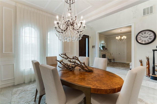 dining space featuring ornamental molding, coffered ceiling, and a notable chandelier