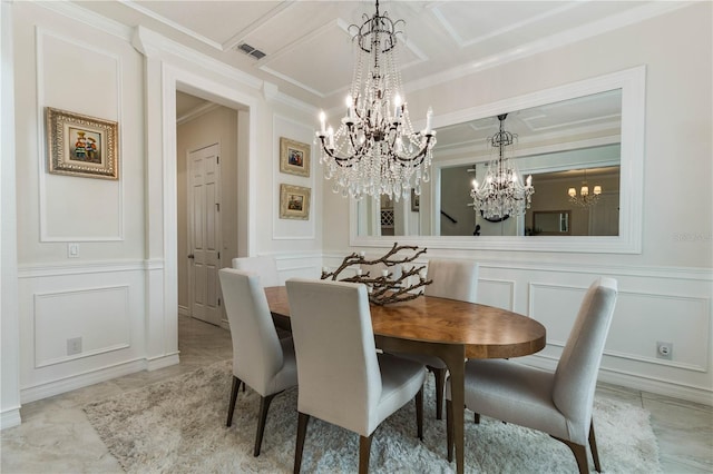 dining space featuring ornamental molding and an inviting chandelier