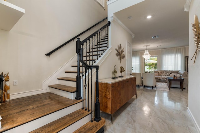 stairs featuring crown molding