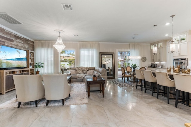 living room featuring ornamental molding and a chandelier