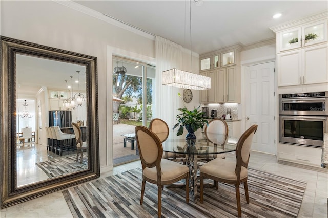 tiled dining room featuring ornamental molding and a notable chandelier