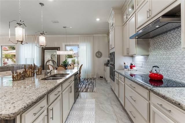 kitchen with sink, appliances with stainless steel finishes, ornamental molding, an island with sink, and backsplash