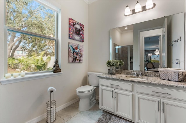 bathroom featuring a shower with door, vanity, and toilet