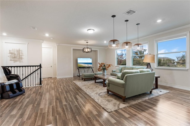 living room featuring hardwood / wood-style flooring and ornamental molding