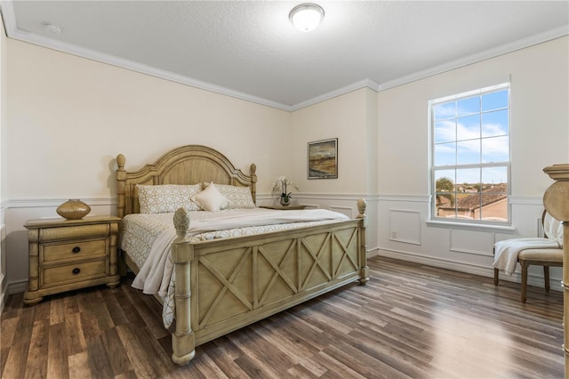 bedroom with dark hardwood / wood-style flooring and crown molding