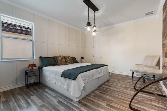 bedroom with crown molding and dark wood-type flooring